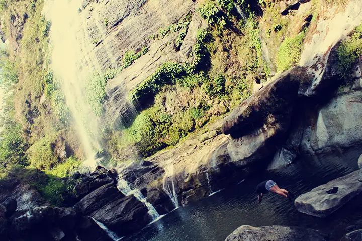 Una persona que había hecho la caminata se zambulle en el río.