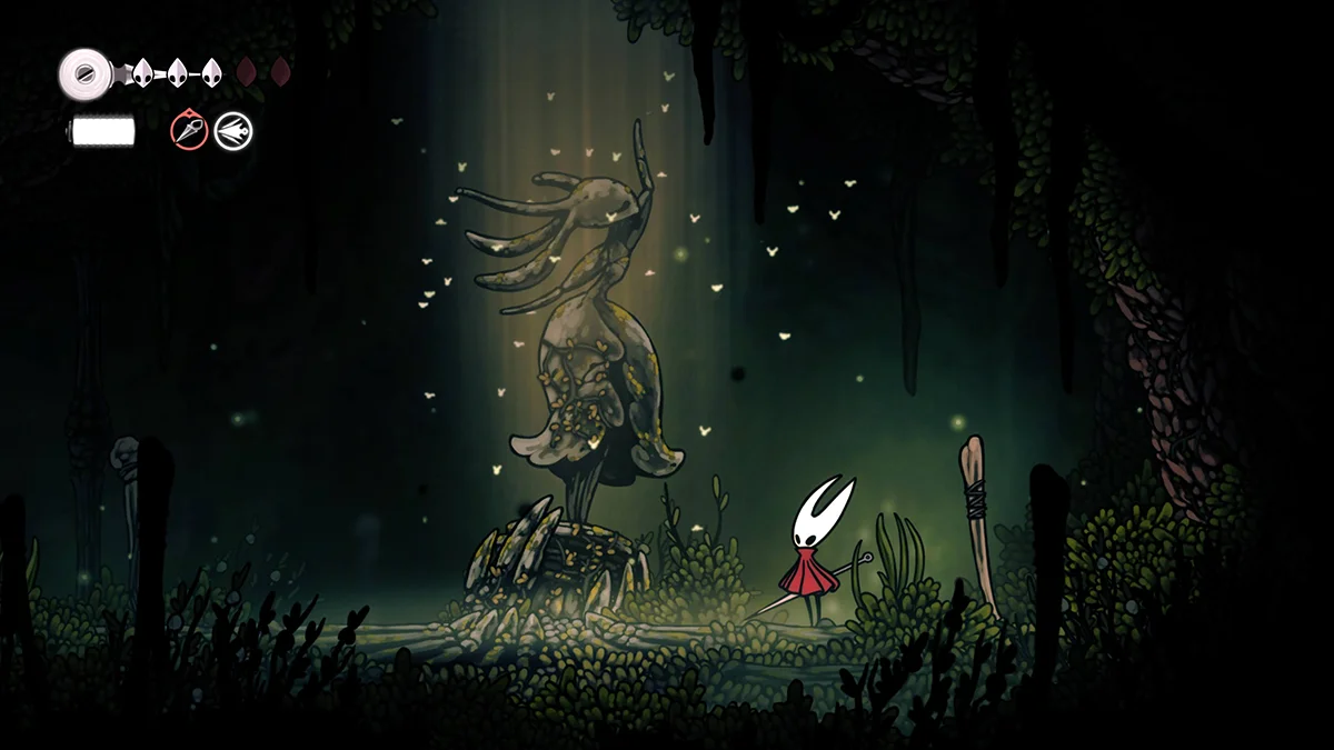 Captura de pantalla de Silksong mostrando a Hornet junto a una hermosa estatua.